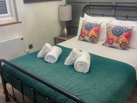 A bedroom with a bed and decorative pillows at Woodburn Lodge Otterburn