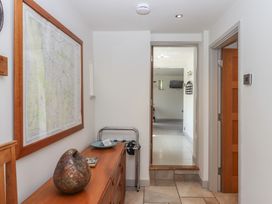 A hallway with a wooden dresser and a framed map on the wall at Puddaven Barn North Bovey near Chagford