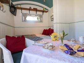 A bedroom with a table and chairs at Songbirds in St Michaels, Kent