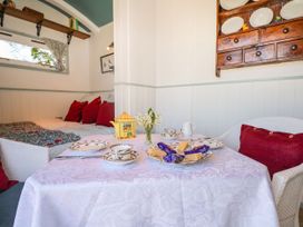 A living room with a table set for tea at Songbirds, St Michaels, Kent
