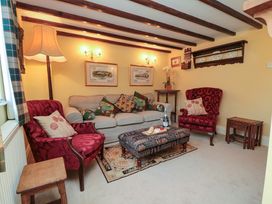 A snug with a sofa and armchairs at Spring Cottage in York