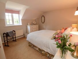A bedroom with a bed and dresser at Spring Cottage in York