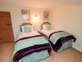 A bedroom with two beds and wall art at Spring Cottage in York