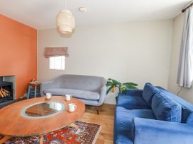 A living room with a sofa, armchair, and coffee table at The Wedge in Mitchell near Summercourt
