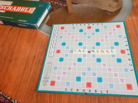 A Scrabble game setup on a wooden table at The Wedge near Summercourt