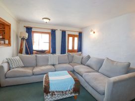 A living room with a sofa and coffee table at The Wedge in Mitchell near Summercourt