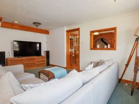 A living room with a television on a stand at The Wedge in Mitchell near Summercourt