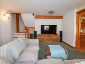 A living room with a sofa and television at The Wedge in Mitchell near Summercourt