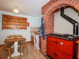 A kitchen with a table and chairs at The Wedge in Mitchell near Summercourt