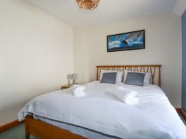 A bedroom with a bed and decorative items at The Wedge in Mitchell near Summercourt