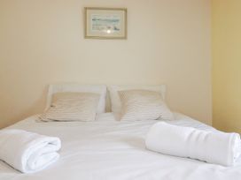 A bedroom with a bed and pillows at The Wedge in Mitchell near Summercourt