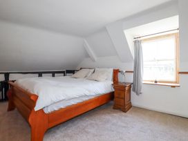 A bedroom with a bed and nightstand at The Wedge in Mitchell near Summercourt