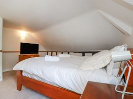 A bedroom with a bed and television at The Wedge in Mitchell near Summercourt