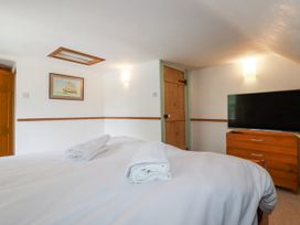 A bedroom with a bed, towels, and a TV at The Wedge in Mitchell near Summercourt