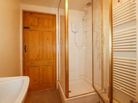 A bathroom with a shower and a bathtub at The Wedge Mitchell near Summercourt
