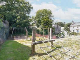 A playground with swings and climbing structures at The Wedge in Mitchell near Summercourt