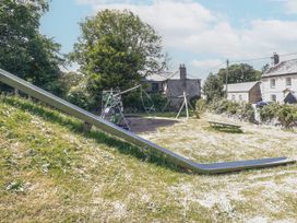 A playground with a slide and swing set at The Wedge in Mitchell near Summercourt
