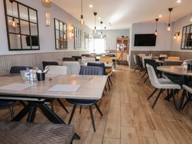A dining room with tables and chairs mirrors on the walls and pendant lights at Number 2 Dome in Derrybeg County Donegal