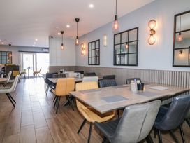 A dining area with tables and chairs with pendant and wall lights at Number 2 Dome in Derrybeg County Donegal