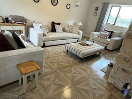 A living room with sofas and a coffee table at Yew Tree Cottage