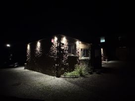A building with lights at night at Yew Tree Cottage Mealsgate near Ireby