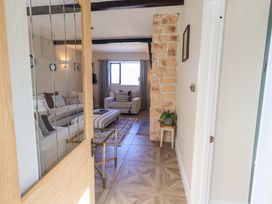 A living room with a sofa and chair at Yew Tree Cottage Mealsgate near Ireby