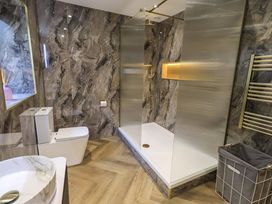 A bathroom with a shower and toilet at Yew Tree Cottage Mealsgate near Ireby