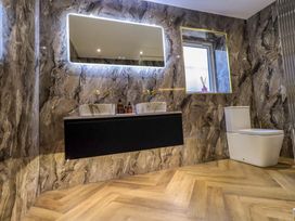 A bathroom with a double sink and toilet at Yew Tree Cottage Mealsgate near Ireby
