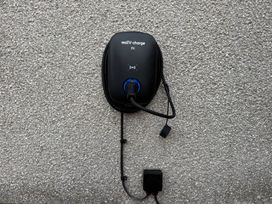 An electric vehicle charger mounted on a wall at Yew Tree Cottage in Mealsgate near Ireby