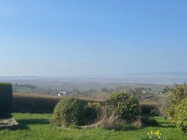 A view of the sea and hills from a garden at Burry House in Llanmorlais