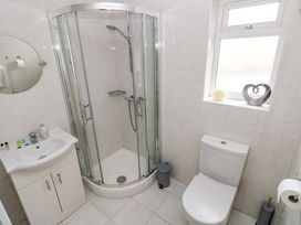 A bathroom with a shower, toilet and sink at Burry House Llanmorlais