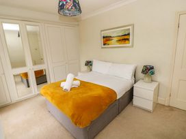 A bedroom with a bed and wardrobe at Burry House in Llanmorlais