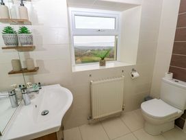 A bathroom with a sink and toilet at Burry House in Llanmorlais