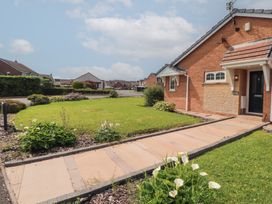 A house with a garden and pathway at 3 Hawk Place in Moresby Parks near Whitehaven