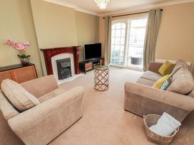 A living room with a sofa and television at 3 Hawk Place in Moresby Parks near Whitehaven