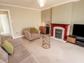 A living room with a sofa and fireplace at 3 Hawk Place Moresby Parks near Whitehaven