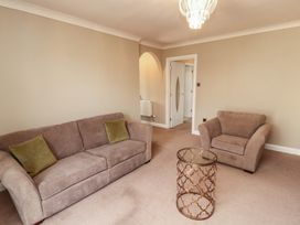 A living room with a sofa and coffee table at 3 Hawk Place Moresby Parks near Whitehaven
