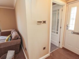 An entrance area with a sofa and door at 3 Hawk Place Moresby Parks near Whitehaven