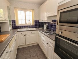 A kitchen with cabinets and appliances at 3 Hawk Place in Moresby Parks near Whitehaven