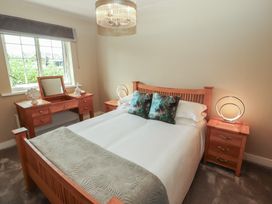 A bedroom with a bed and furniture at 3 Hawk Place Moresby Parks near Whitehaven