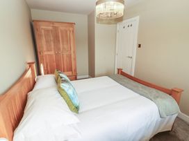 A bedroom with a bed and wardrobe at 3 Hawk Place in Moresby Parks near Whitehaven