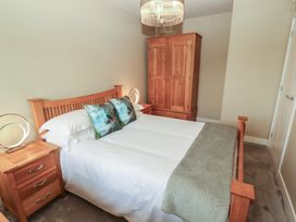 A bedroom with a bed and wardrobe at 3 Hawk Place in Moresby Parks near Whitehaven