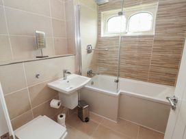A bathroom with a bathtub, sink, and toilet at 3 Hawk Place in Moresby Parks near Whitehaven
