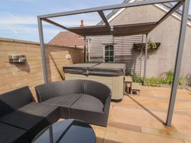 An outdoor area with a hot tub and seating at 3 Hawk Place Moresby Parks near Whitehaven