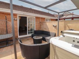 An outdoor patio area with seating and a hot tub at 3 Hawk Place Moresby Parks near Whitehaven