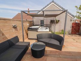 An outdoor seating area with a hot tub at 3 Hawk Place, Moresby Parks near Whitehaven