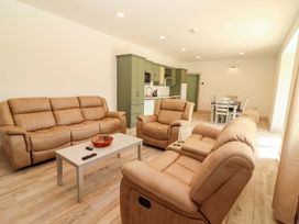 A living room with sofas and a coffee table at Teach Ti in Miltown Malbay