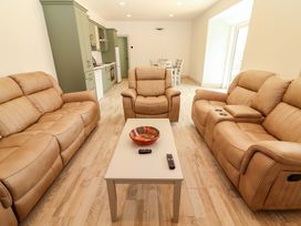A living room with sofas and a coffee table at Teach Ti in Miltown Malbay