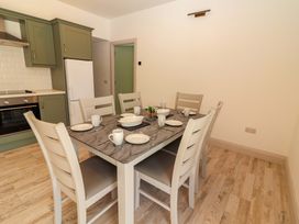 A dining room with a table set for meals at Teach Ti in Miltown Malbay