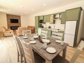 A kitchen and dining area with table and chairs at Teach Ti in Miltown Malbay